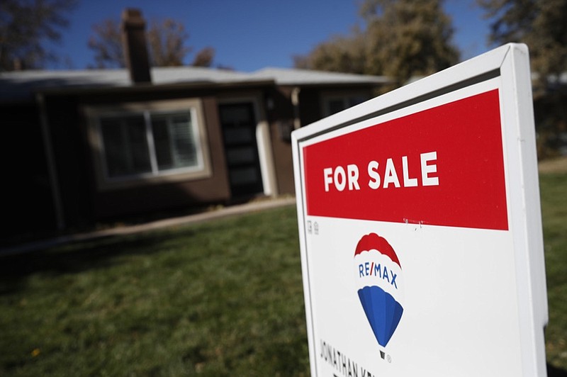 FILE - In this Oct. 22, 2019 file photo, a sign stands outside a home for sale in southeast Denver. U.S. long-term mortgage rates were little changed this week of Dec. 23, remaining at historically low levels to prod prospective homebuyers. (AP Photo/David Zalubowski, File)


