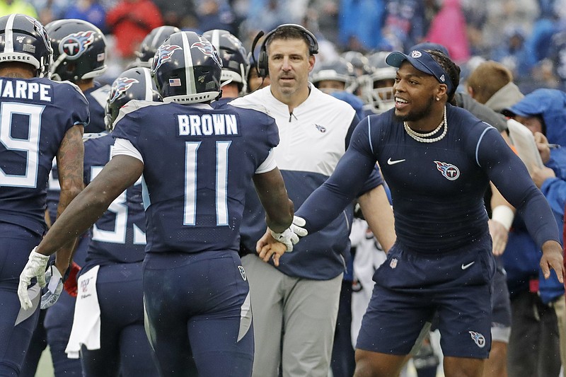 Tennessee Titans wide receiver A.J. Brown is congratulated by injured running back Derrick Henry, right, after scoring on a 49-yard touchdown run against the New Orleans Saints last Sunday in Nashville. / AP photo by James Kenney