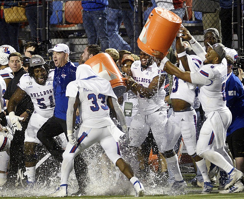 Louisiana Tech head coach Skip Holtz (white cap) is doused by his players after they won the NCAA college football Independence Bowl against Miami, Thursday, Dec. 26, 2019, at Independence Stadium in Shreveport, La. (Henriette Wildsmith/The Shreveport Times via AP)
