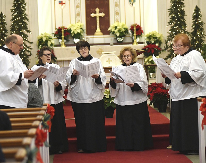 Members of the St. Peter's Episcopal Church Choir open worship on Tuesday December 24, 2019, evening in Ashtabula, Ohio.  (Warren Dillaway/The Star-Beacon via AP)