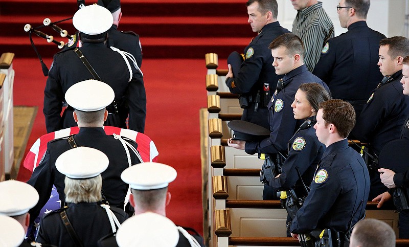 As the casket of fallen Chattanooga police officer Nicholas Galinger is taken to the far end of the chapel at Mt. Washington Presbyterian Church fellow Chattanooga police officers look on Friday, March 1, 2019 in Cincinnati, Ohio. More than 50 Chattanooga police officers made the trip to Cincinnati for Galinger's visitation and funeral. / Staff photo by Erin O. Smith