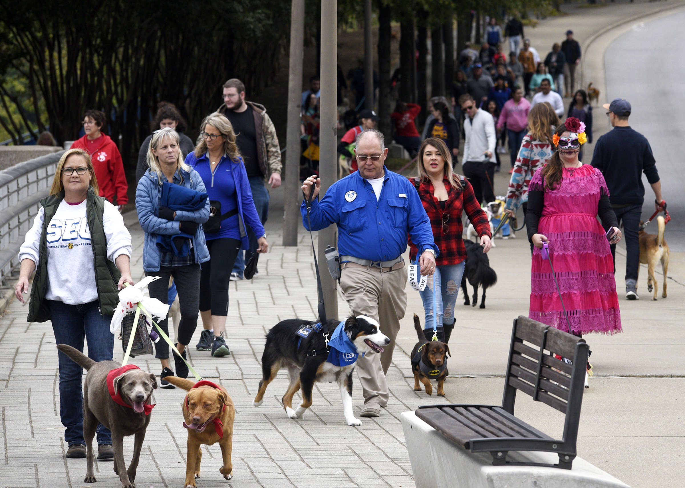 Staff Photo by Robin Rudd/ Walk participants make their way back to Ross's Landing. Hundreds of animals lovers gathered to raise money for the Humane Educational Society at the 17th annual Paws in the Park. The event included a walk, dog and human costume contest, and a dog cake-eating contest. Ross's Landing Park was the site of the event on October 19, 2019.