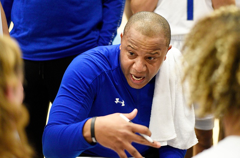 Cleveland boys' basketball coach Reggie Tucker talks to his players during a quarter break in Friday night's game against Howard at the Chatt-Town Classic at Chattanooga State. / Staff photo by Robin Rudd