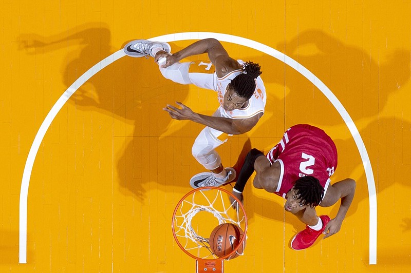 Wisconsin's Aleem Ford, right, and Tennessee's Yves Pons watch the basketball as it falls into the net during Saturday's game at Thompson-Boling Arena in Knoxville. Wisconsin won 68-48 in Tennessee's final game before hosting LSU next Saturday to open its SEC schedule. / AP photo by Calvin Mattheis