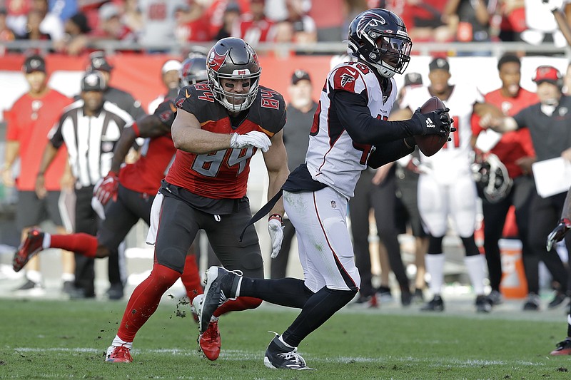 Atlanta Falcons linebacker Deion Jones intercepts a pass by Tampa Bay Buccaneers quarterback Jameis Winston, not pictured, that was intended for tight end Cameron Brate, left, and returns it for the winning touchdown during overtime Sunday in Tampa, Fla. / AP photo by Chris O'Meara