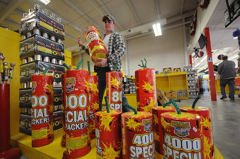 In this 2013 staff file photo, Patrick Heller, of Atlanta, considers a package of 1,600 firecrackers at Dixieland Fireworks in East Ridge. / Staff File photo by Tim Barber