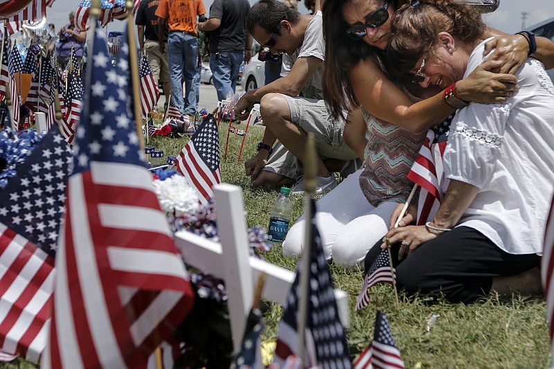 Deborah Wyatt Boen, right, mother of U.S. Marine Corps Staff Sgt. David Wyatt, and Deanna Wyatt Trent, his sister, mourn at a Lee Highway memorial for Staff Sgt. Wyatt and other victims of the July, 16 shootings on Saturday, July 18, 2015, in Chattanooga, Tenn. U.S. Navy Petty Officer Randall Smith died Saturday from wounds sustained when gunman Mohammad Youssef Abdulazeez shot and killed four U.S. Marines and wounded two others and a Chattanooga police officer at the Naval Operational Support Center on Amnicola Highway shortly after firing into the Armed Forces Career Center on Lee Highway. / Staff photo by Doug Strickland
