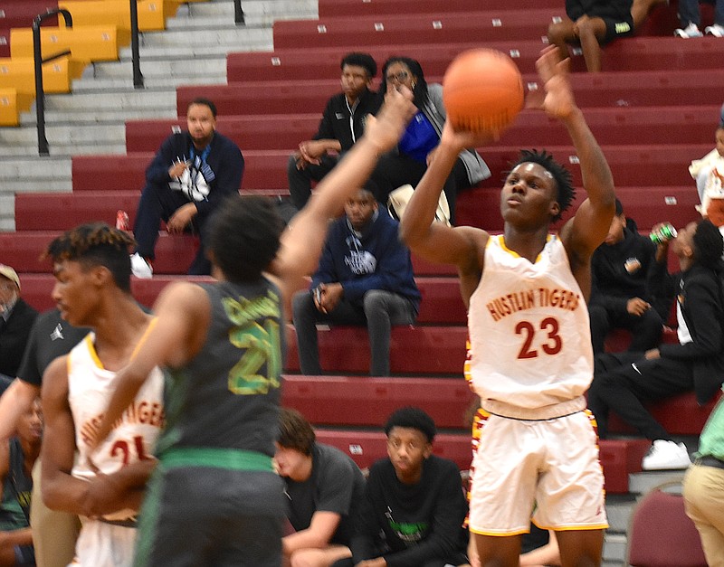 Howard's Calvin James drains a left-corner shot for three of his 20 points in Monday's home victory over East Hamilton. / Staff photo by Patrick MacCoon