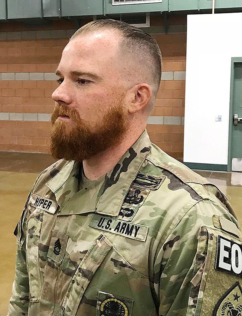 This August 2019 photo provided by the Nevada Army National Guard shows Sgt. 1st Class Benjamin Hopper of the Nevada Army National Guard at a deployment ceremony in Nevada. Hopper, who is serving in Afghanistan, has received a uniform religious exception to sport a beard based upon his Norse pagan beliefs. He is the first guard soldier to receive a religious accommodation approval for a beard. (Sgt. 1st Class Erick Studenicka/Nevada Army National Guard via AP)