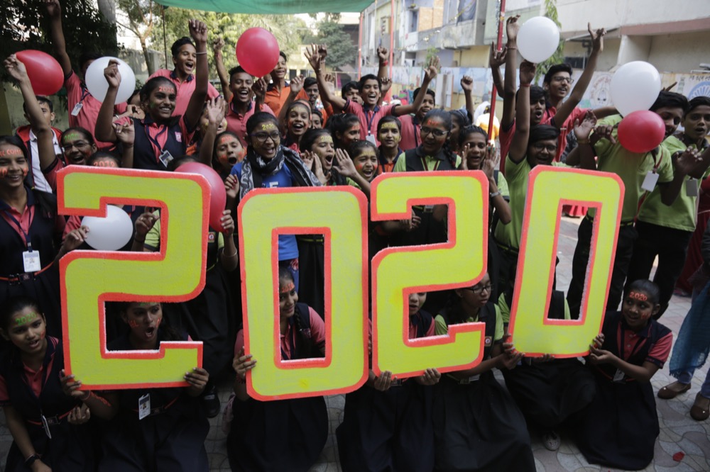 Indian school children pose for the cameras during an event to welcome the New Year in Ahmadabad, India, Tuesday, Dec. 31, 2019. (AP Photo/Ajit Solanki)