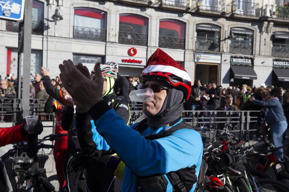 A group of cyclists celebrate during a rehearsal for midnight new year celebrations in Madrid, Spain, Tuesday, Dec. 31, 2019. (AP Photo/Paul White)