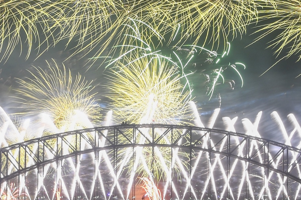 Midnight fireworks explode over the Sydney Harbour Bridge during New Year's eve celebrations in Sydney, Tuesday, Dec.31, 2019. (Lukas Coch/AAP Images via AP)
