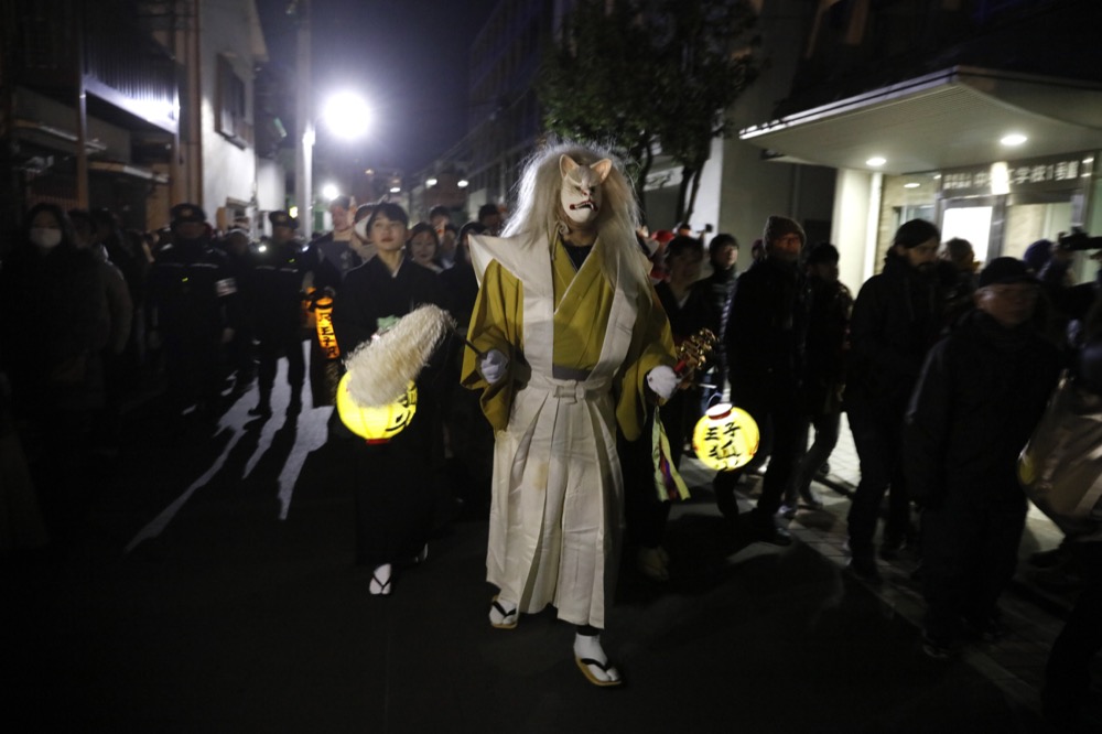 A man wearing a fox mask participates in a parade held to celebrate the New Year Wednesday, Jan. 1, 2020, in Tokyo. (AP Photo/Jae C. Hong)