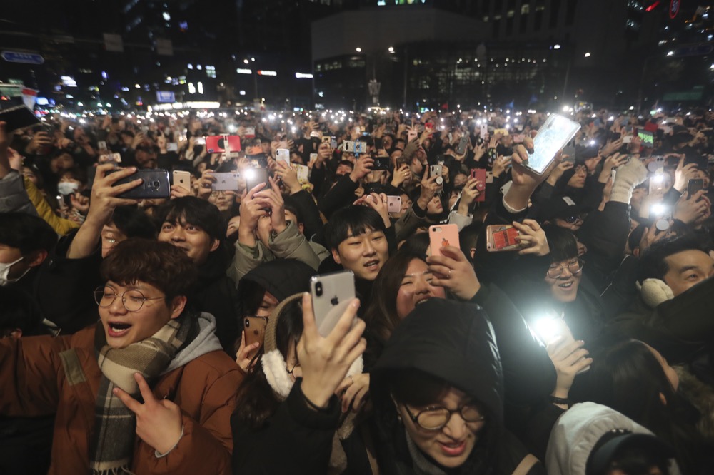 People attend New Year celebrations in Seoul, South Korea, Wednesday, Jan. 1, 2020. (AP Photo/Ahn Young-joon)