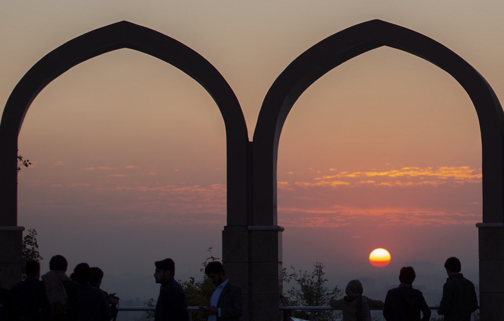 People watch the last sunset of 2019 at a park in Islamabad, Pakistan, Tuesday, Dec. 31, 2019. (AP Photo/B.K. Bangash)