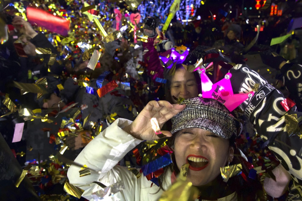People celebrate the arrival of the year 2020 at a New Year's Eve countdown event near the 2022 Beijing Winter Olympic headquarters in Bejing, Wednesday, Jan. 1, 2020. Revellers around the globe are bidding farewell to a decade that will be remembered by many for the rise of social media, the Arab Spring, the #MeToo movement and, of course, President Donald Trump. (AP Photo/Ng Han Guan)
