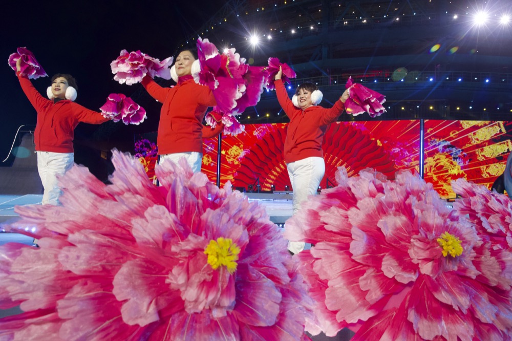 Performers rehearse before a New Year's Eve countdown event near the 2022 Beijing Winter Olympic headquarters in Beijing, Tuesday, Dec. 31, 2019. Revellers around the globe are bidding farewell to a decade that will be remembered by many for the rise of social media, the Arab Spring, the #MeToo movement and, of course, President Donald Trump. (AP Photo/Ng Han Guan)