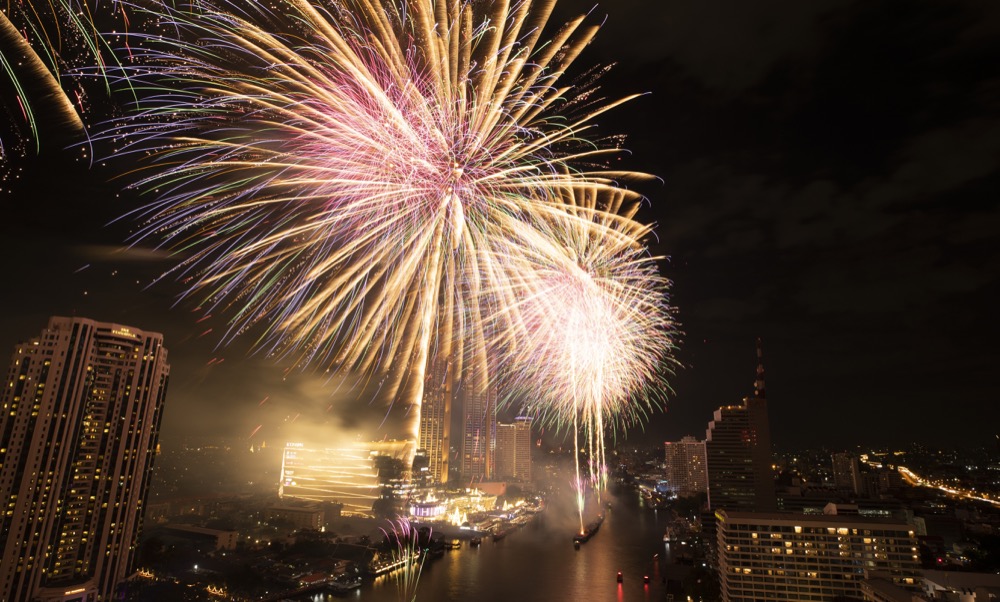 Fireworks explode over the Chao Phraya River during New Year celebrations in Bangkok, Thailand, Wednesday, Jan. 1, 2020. (AP Photo/Sakchai Lalit)