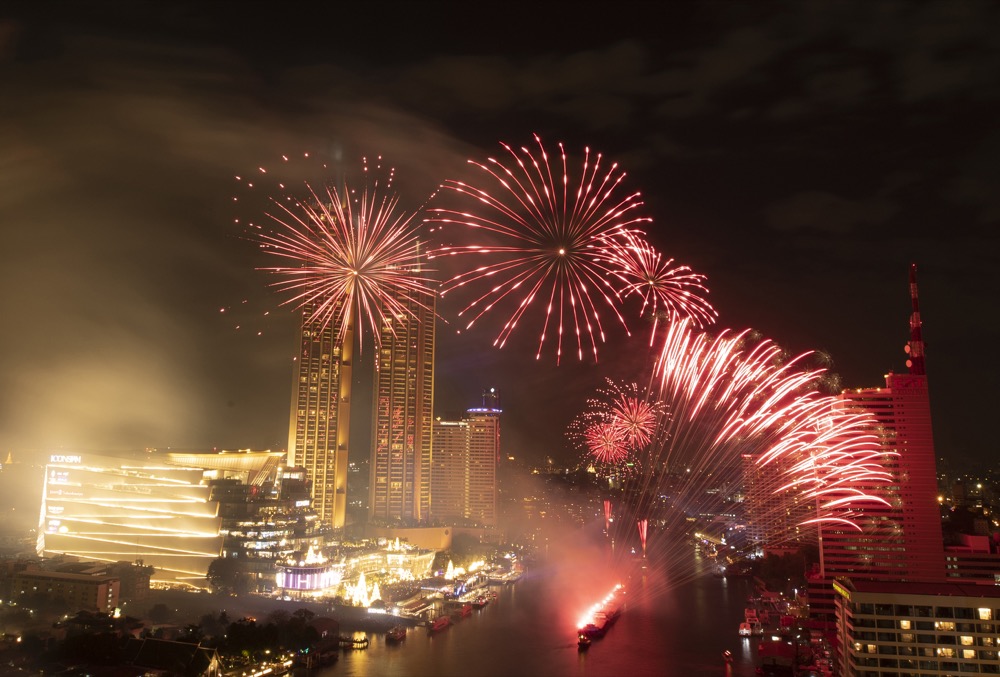 Fireworks explode over the Chao Phraya River during New Year celebrations in Bangkok, Thailand, Wednesday, Jan. 1, 2020. (AP Photo/Sakchai Lalit)