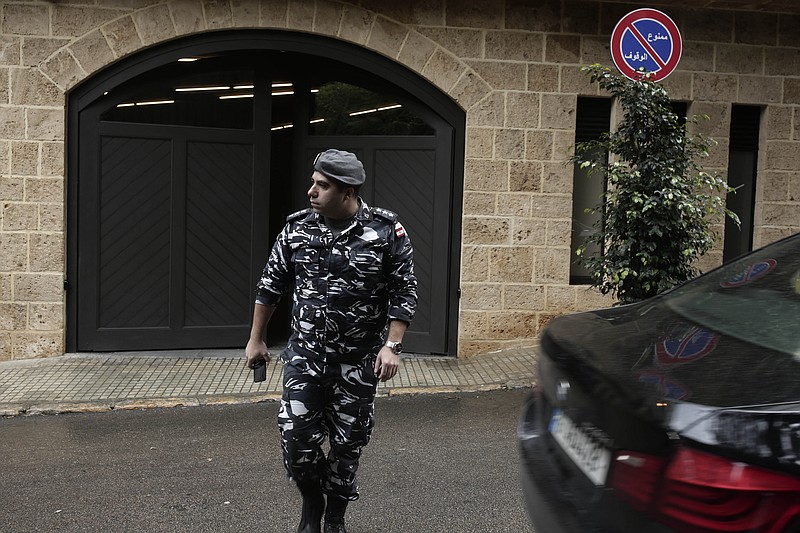 A policeman leaves the residence of former Nissan Chairman Carlos Ghosn on Tuesday, Dec. 31, 2019 in Beirut, Lebanon. A close friend says Ghosn, who is awaiting trial in Japan, has arrived in Beirut. It was not clear how Ghosn, who is of Lebanese origins, left Japan where he is under surveillance and is expected to face trial in April 2020. (AP Photo/Maya Alleruzzo)