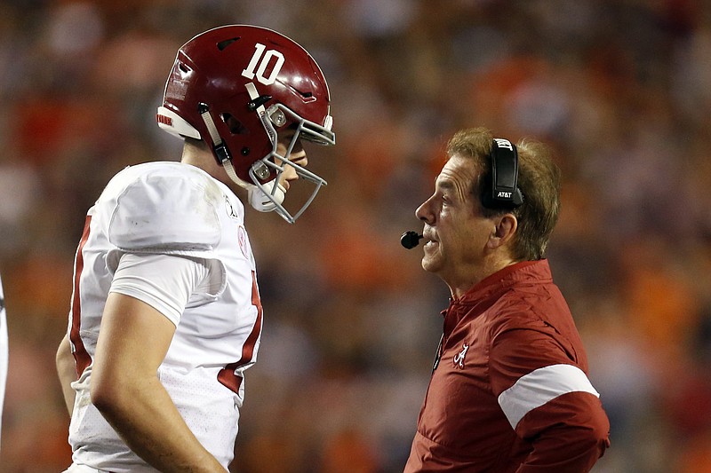 AP photo by Butch Dill / Alabama quarterback Mac Jones talks with coach Nick Saban during the team's game at Auburn on Nov. 30, 2019.