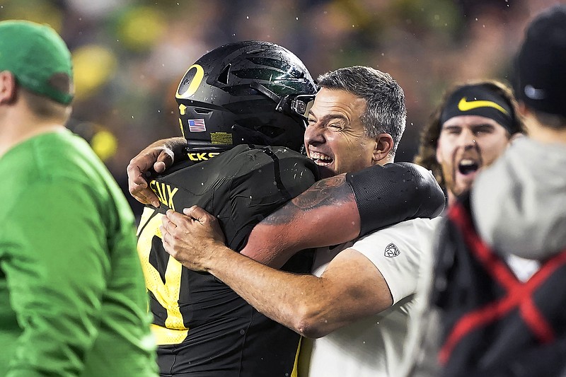 FILE - In this Dec. 6, 2018, file photo, Oregon coach Mario Cristobal, right, celebrates with offensive lineman Shane Lemieux (68) after Oregon defeated Utah 37-15 in an NCAA college football game for the Pac-12 Conference championship, in Santa Clara, Calif. Cristobal was named The Associated Press Pac-12 Coach of the Year Thursday, Dec. 12, 2019. (AP Photo/Tony Avelar, File)