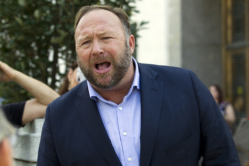 In this Sept. 5, 2018, file photo conspiracy theorist Alex Jones speaks outside of the Dirksen building of Capitol Hill in Washington. On Dec. 20, 2019, a Texas judge ordered Jones to pay $100,000 in legal fees in another setback to the Infowars host, who is being sued by families of children killed in the 2012 Sandy Hook school shooting for calling the attack a hoax. (AP Photo/Jose Luis Magana, File)