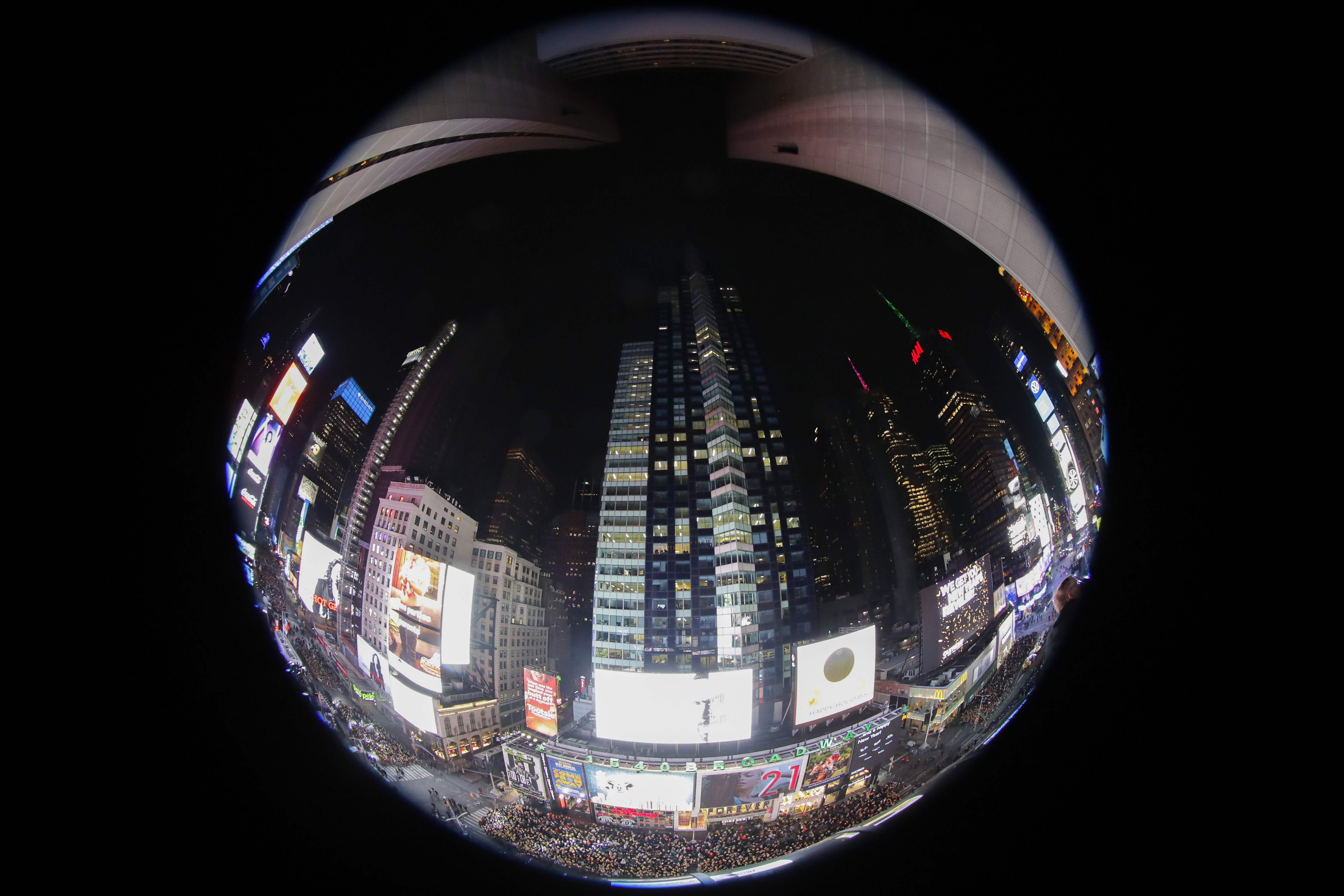Revelers wait for midnight during the New Year's Eve celebration in New York's Times Square, as seen from above with a fisheye lens from the New York Marriott Marquis hotel, Tuesday, Dec. 31, 2019. (AP Photo/Frank Franklin II)