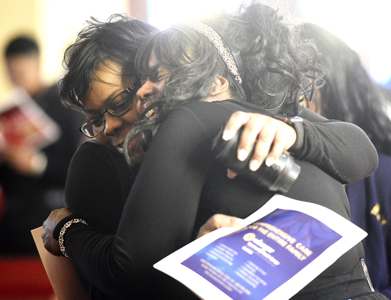 Staff Photo by Robin Rudd/   Two women embrace during the Black National Anthem.