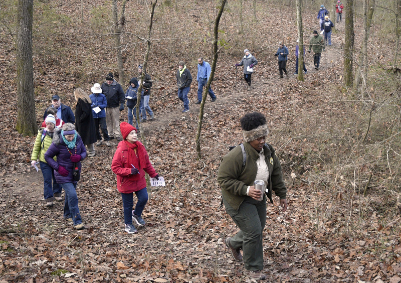 Staff Photo by Robin Rudd/   Before the rising sun has reached them Kahla Stewart with Appalachia CARES/AmeriCorps and Booker T. Washington State Park leads the hikers at the start of their trek.  Booker T. Washington State Park kicked off the new year and decade hosting a two-mile first day hike on January 1, 2020.  Booker T. Washington State Park kicked off the new year and decade hosting a two-mile first day hike on January 1, 2020.