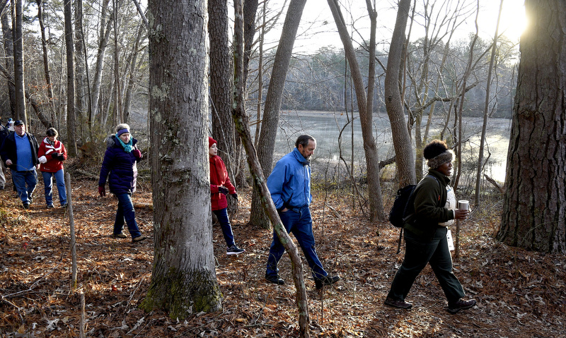 Staff Photo by Robin Rudd/   The light of the first day of 2020 finds the hikers as they reach the north side of the slough.  Booker T. Washington State Park kicked off the new year and decade hosting a two-mile first day hike on January 1, 2020.