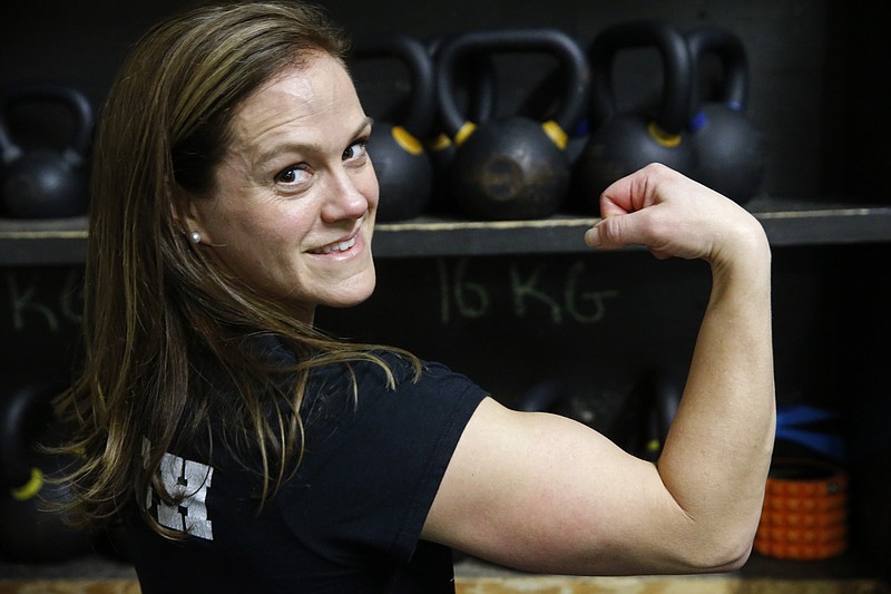 Melissa Breaux Bankston, a CrossFit athletic trainer at CrossFit Algiers in New Orleans, poses for a portrait at the gym Monday, Dec. 23, 2019. She participates in an intermittent fasting diet. (AP Photo/Gerald Herbert)