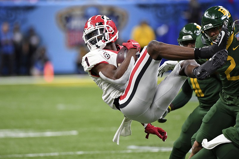 Georgia wide receiver George Pickens is upended by Baylor linebacker Blake Lynch during the first half of the Sugar Bowl on Wednesday night in New Orleans. Pickens finished with 12 catches for 175 yards and a touchdown to help the Bulldogs win 26-14. / AP photo by Bill Feig