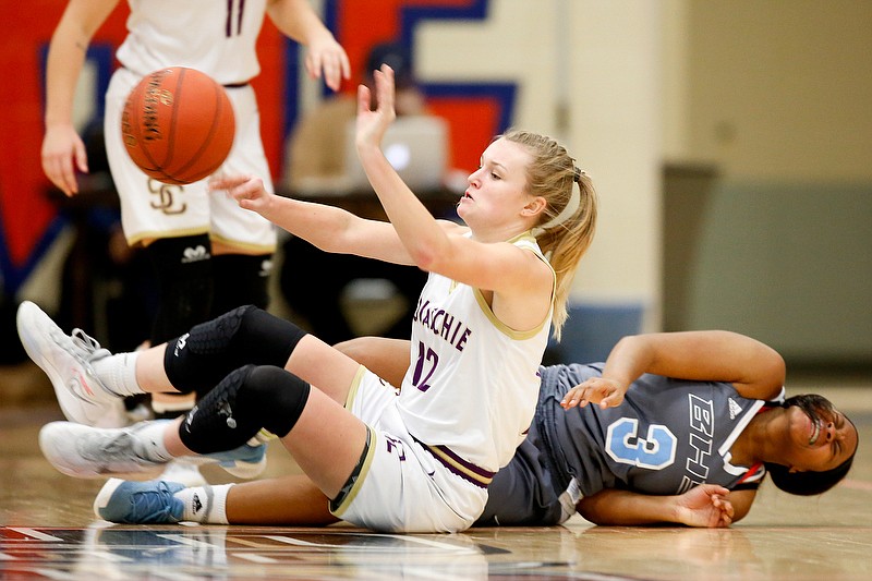 Sequatchie County's Dylan Belk, left, passes the ball from the floor after getting tangled up with Brainerd's Tyliyah Ward (3) during a Times Free Press Best of Preps Tournament first-round game Thursday at Chattanooga State. / Staff photo by C.B. Schmelter