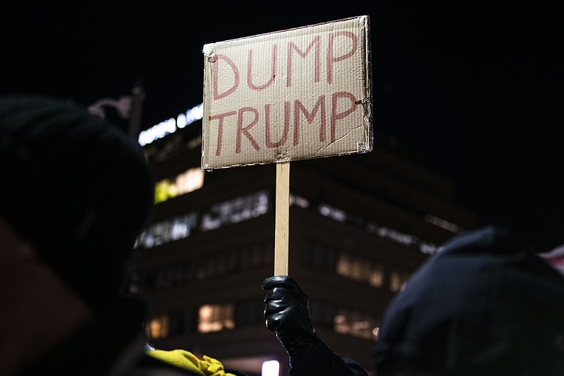 Protesters hold signs and chant during a President Donald J. Trump impeachment rally in downtown Ann Arbor on Tuesday, Dec. 17, 2019. The rally, was one of many held around the U.S. on the eve of President Trump's impeachment vote. (Nicole Hester/Ann Arbor News via AP)