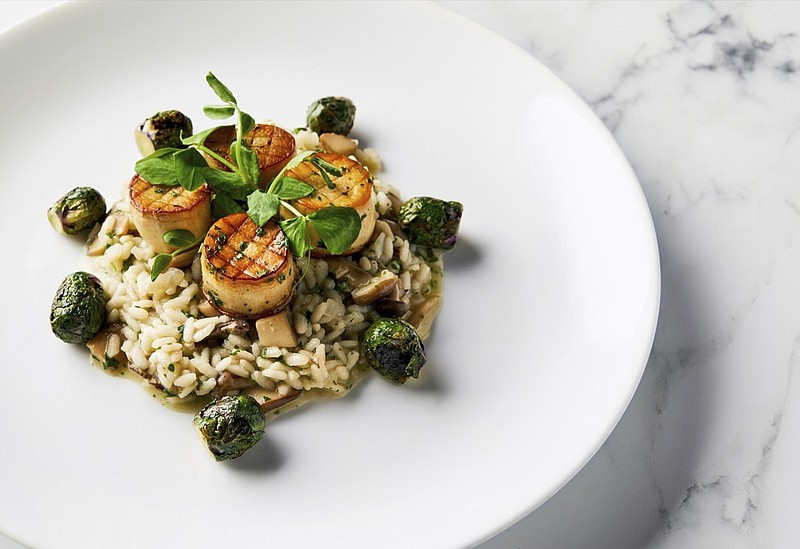 This image released by the Golden Globe Awards shows a dish of king oyster mushroom scallops on a bed of wild mushroom risotto with roasted Brussels sprouts, prepared by Beverly Hilton Executive Chef Matthew Morgan. The dish will be served at the Golden Globe Awards on Sunday. (Leslie Grow/Golden Globe Awards via AP)


