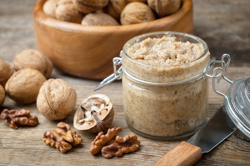 Raw organic walnut butter and fresh nuts / Getty Images
