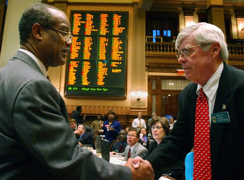 Georgia state Rep. Calvin Smyre, D-Columbus, left, congratulates Rep. Tom Buck, D-Columbus, as the House passes the budget during the last day of the session Friday, April 25, 2003, at the Capitol in Atlanta. (AP Photo/Gregory Smith)
