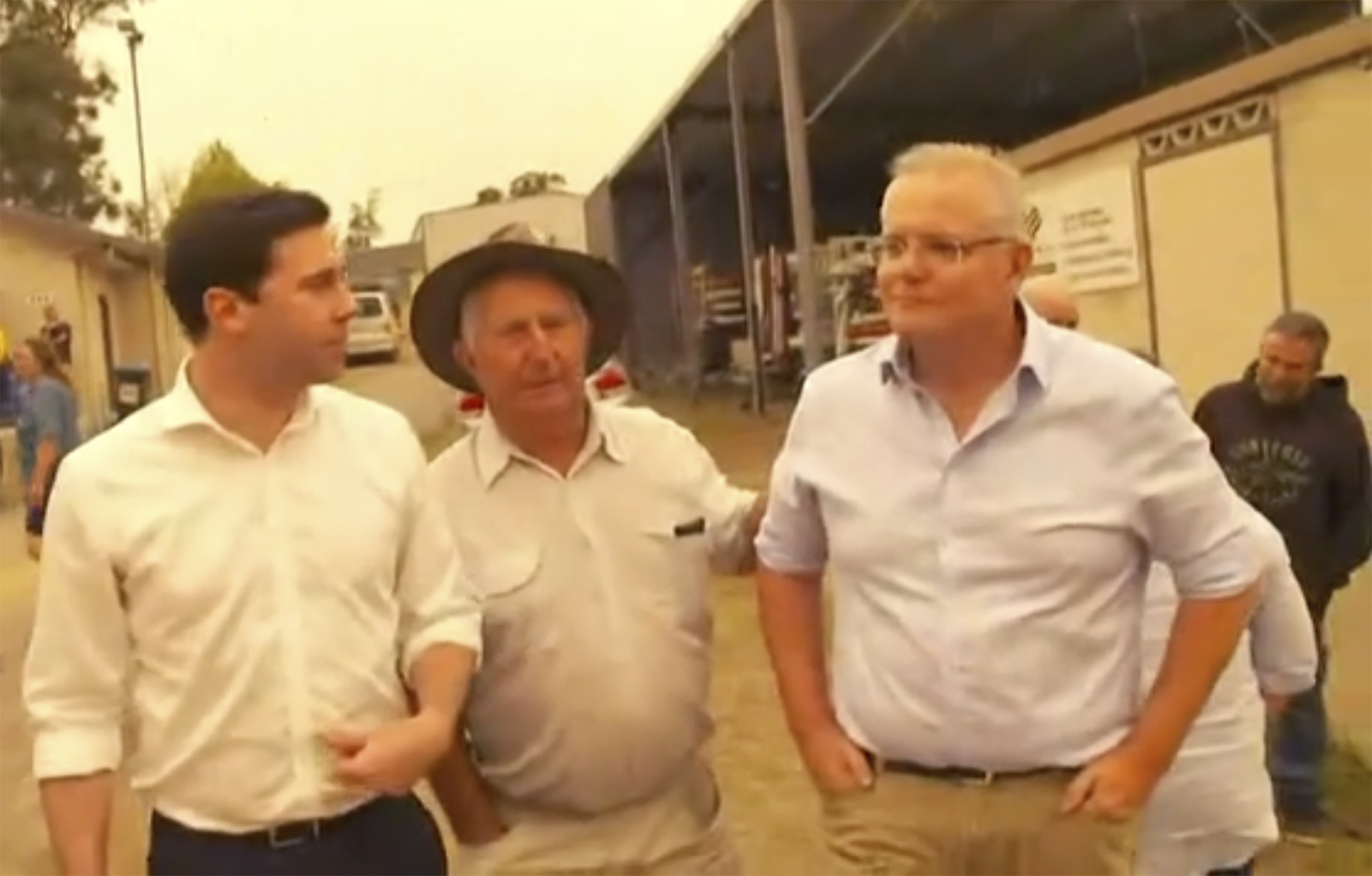 This still image taken from video provided by AuBC, Australian Prime Minister Scott Morrison is confronted by angry residents as he visited a wildfire-ravaged Cobargo, in New South Wales on Thursday, Jan. 2, 2020. The outpouring of anger came as authorities said 381 homes had been destroyed on the New South Wales southern coast this week.   More than 200 fires are burning in Australia's two most-populous states. (AuBC via AP)