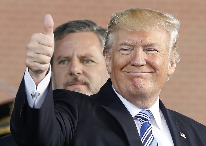In this May 13, 2017 file photo, President Donald Trump, right, gives a thumbs up as Liberty University president, Jerry Falwell Jr., left, watches during of commencement ceremonies at the school in Lynchburg, Va. In his first campaign move of the 2020 election year, President Donald Trump on Friday will launch a coalition of evangelicals as he aims to shore up and expand support from an influential piece of his political base. (AP Photo/Steve Helber)