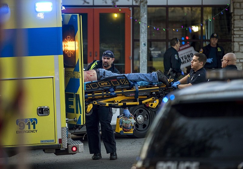 Paramedics transport a stabbing victim in Austin, Texas, on Friday, Jan. 3, 2020. (Jay Janner/Austin American-Statesman via AP)

