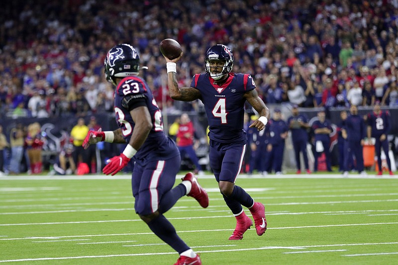 Houston Texans quarterback Deshaun Watson (4) throws a touchdown pass to running back Carlos Hyde during the second half of their team's AFC wild-card playoff game against the Buffalo Bills on Saturday in Houston. / AP photo by Michael Wyke