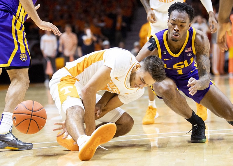 Tennessee guard Santiago Vescovi reaches between his legs in pursuit of a loose ball alongside LSU guard Javonte Smart during Saturday's game in Knoxville. / AP photo by Brianna Paciorka
