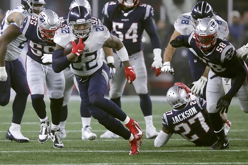 Tennessee Titans running back Derrick Henry dashes away from New England Patriots defenders during the first half of Saturday's AFC wild-card playoff game in Foxborough, Mass. Henry rushed for 182 yards to help lead the Titans to a 20-13 win. / AP photo by Charles Krupa