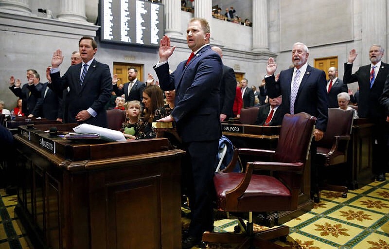 Rep. William Lamberth, R-Cottontown, center, and other members of the House of Representatives take the oath of office on the opening day of the 111th General Assembly Tuesday, Jan. 8, 2019, in Nashville, Tenn. (AP Photo/Mark Humphrey)