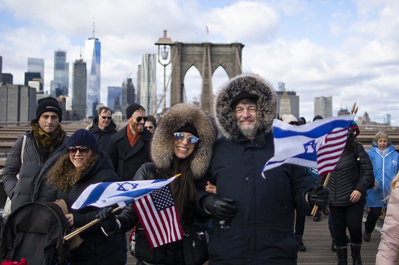 People take part in a march crossing the Brooklyn Bridge in solidarity with the Jewish community after recent string of anti-semitic attacks throughout the greater New York area, on Sunday, Jan. 5, 2020 in New York.  (AP Photo/Eduardo Munoz Alvarez)