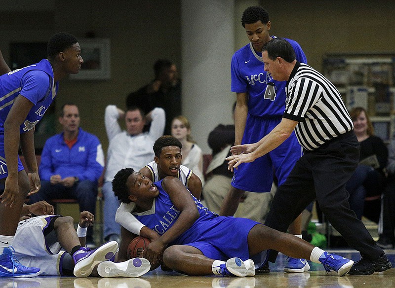 McCallie's Adrian Thomas, bottom, and Central's Jamichael Poole struggle for a loose ball during a Dr. Pepper Classic game at McCallie on Feb. 6, 2016. Thomas, now a senior at Sewanee, reached 1,000 points for his collegiate career in a road win Sunday. / Staff photo