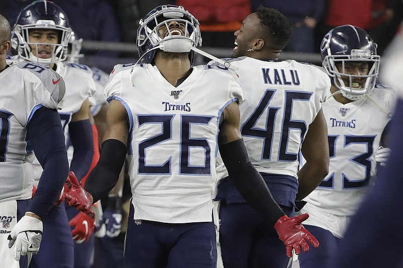 Tennessee Titans cornerback Logan Ryan celebrates after returning an interception for a touchdown near the end of his team's 20-13 playoff win against the New England Patriots on Saturday night in Foxborough, Mass. / AP photo by Steven Senne