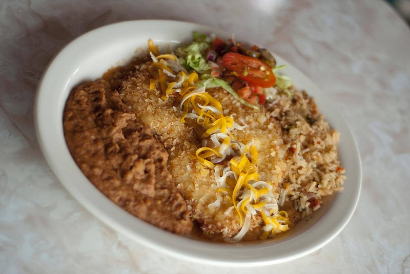 Photo from Chuy's / For the restaurant chain's annual Elvis Birthday Bash, Chuy's will offer $1 off their signature Elvis Green Chile Fried Chicken, a chicken breast breaded with Lay's potato chips and fried golden brown, then served with green chile sauce and cheese.