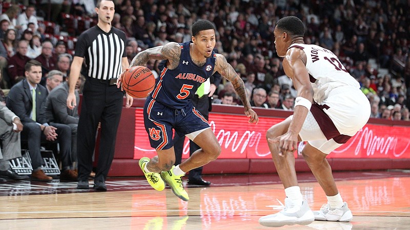 Auburn senior point guard J'Von McCormick, left, had a career-high 28 points Saturday as the Tigers improved to 13-0 with an 80-68 win at Mississippi State.